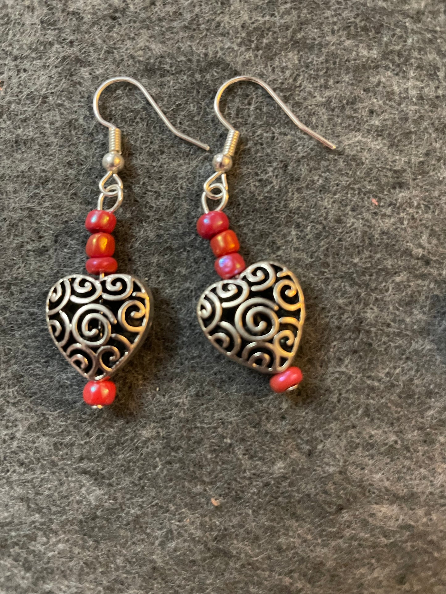 Small silver toned scrollwork heart earrings